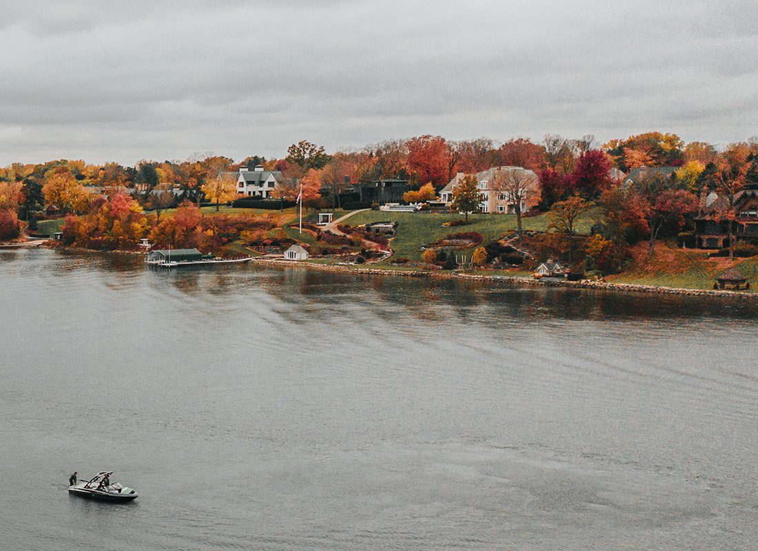 Contact - Lake Town During the Fall and a Small Boat in the Lake